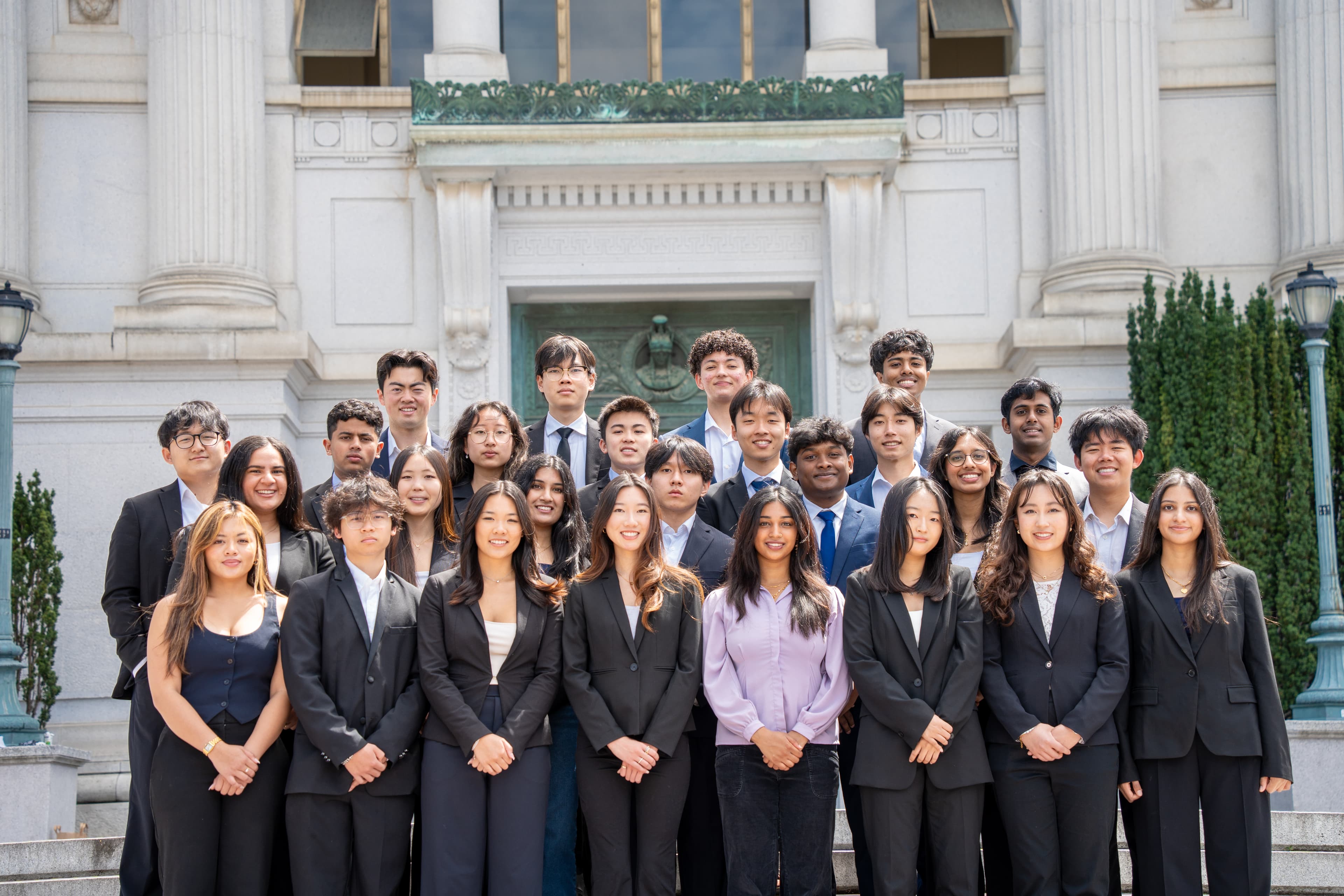 SPC formal group photo on the steps of a building